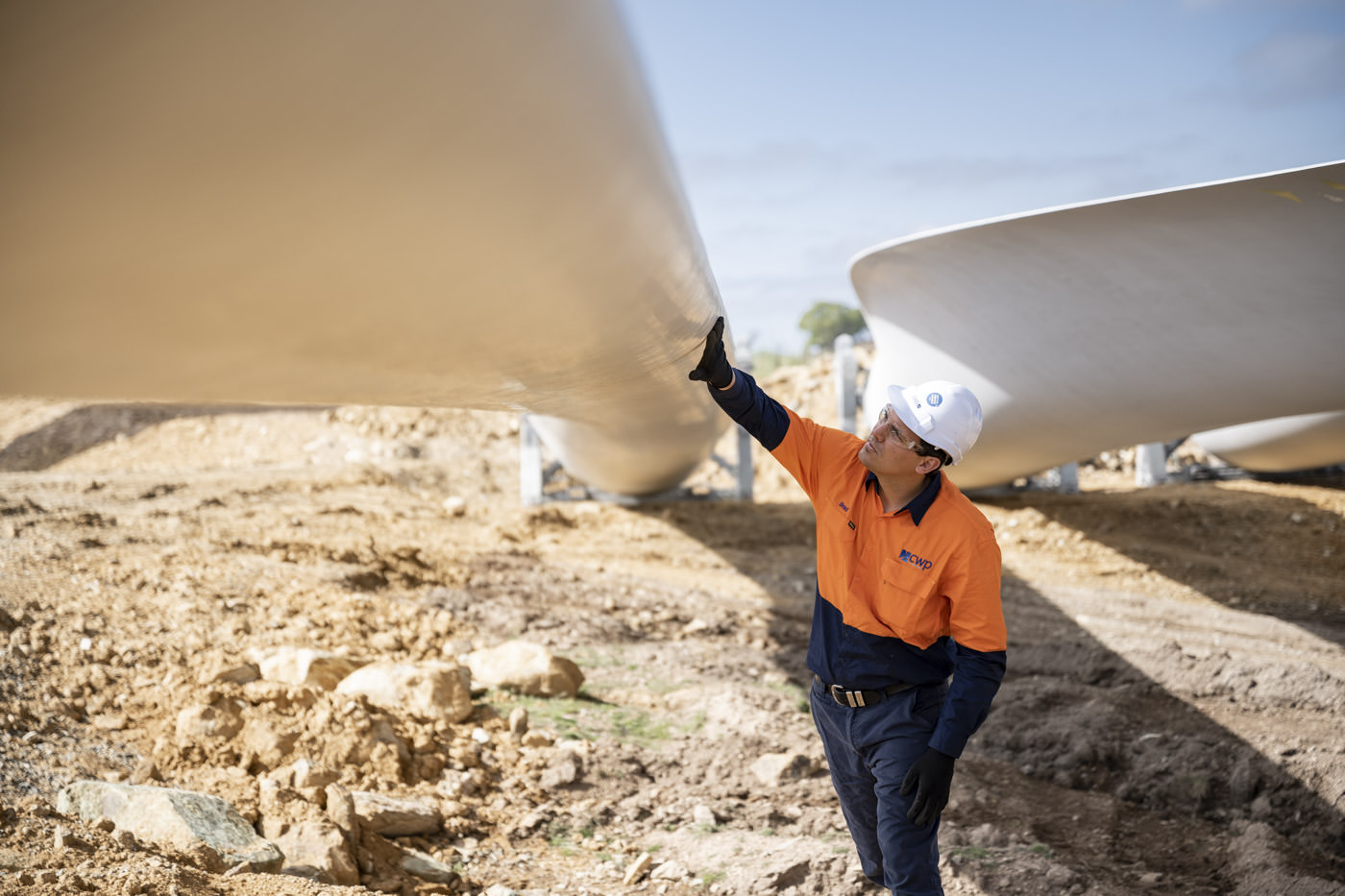 Industrial Photography of engineer inspecting a wind turbine blade