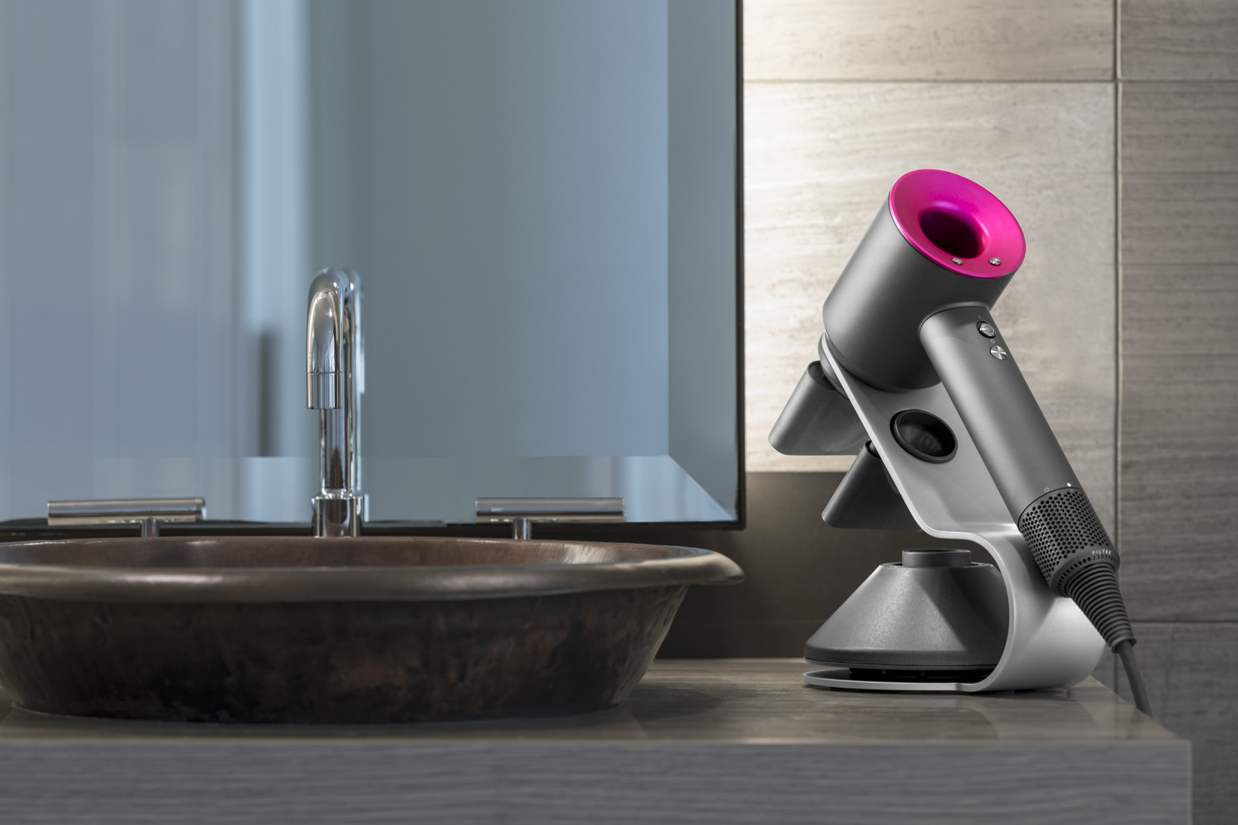 Product photography of a Dyson hairdryer displayed in a Sydney hotel bathroom A sleek product photograph featuring a Dyson hairdryer with a vibrant pink accent, elegantly placed on a countertop next to a contemporary sink and faucet in a stylish Sydney hotel bathroom.